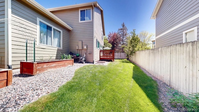 2980 E 135th Dr, Thornton, CO 80241 - fenced backyard featuring a vegetable garden and a wooden deck