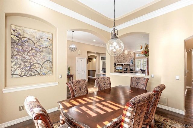 dining area with ornamental molding and dark wood-type flooring