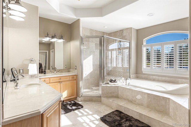 bathroom featuring tile patterned flooring, shower with separate bathtub, and vanity