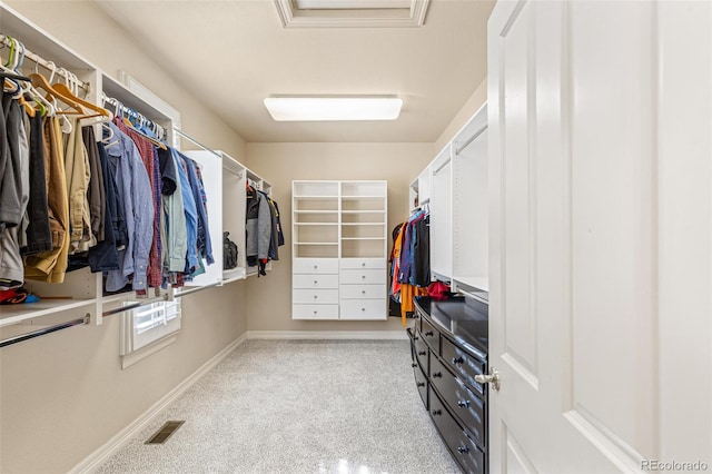 walk in closet with light colored carpet