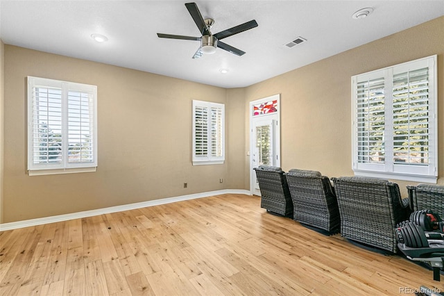 office space featuring ceiling fan and light wood-type flooring