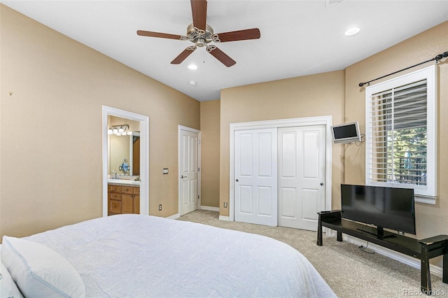 carpeted bedroom featuring connected bathroom and ceiling fan