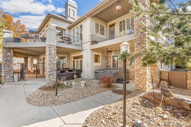 exterior space featuring a hot tub