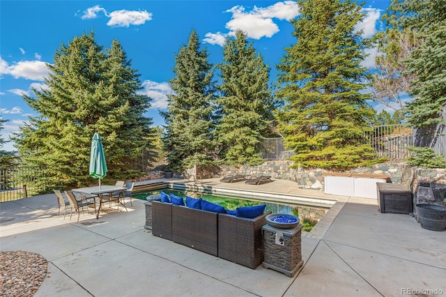 view of patio / terrace with an outdoor living space and a fenced in pool