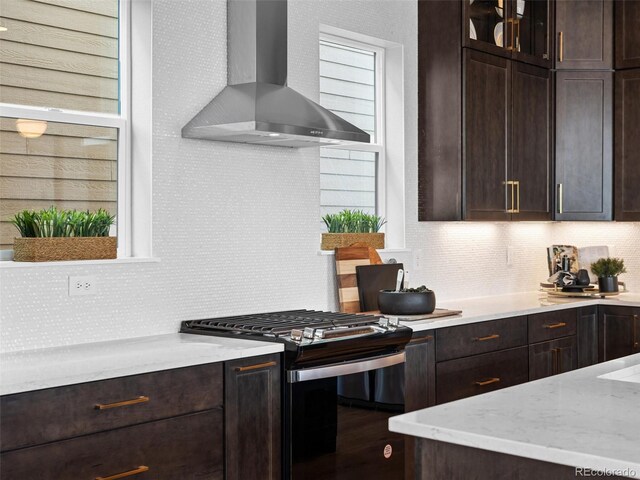 6244 N Lisbon St, Aurora, CO 80019 - kitchen featuring gas range oven, wall chimney exhaust hood, and tasteful backsplash