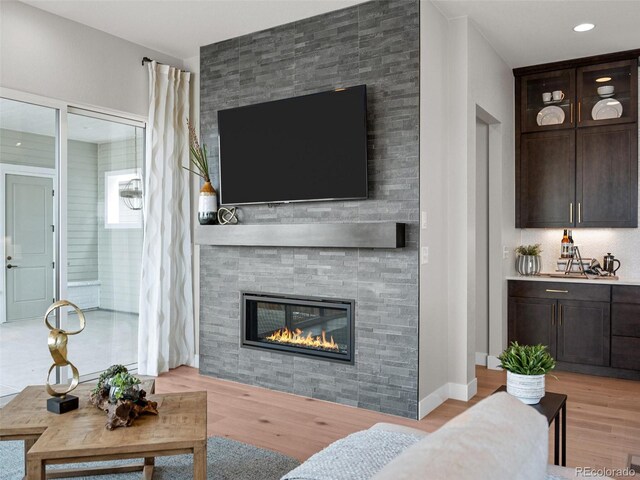 6244 N Lisbon St, Aurora, CO 80019 - living room featuring light wood-style flooring and a large fireplace
