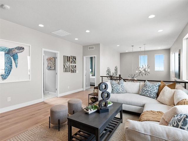 6244 N Lisbon St, Aurora, CO 80019 - living room with light wood-style floors, recessed lighting, and baseboards