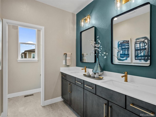6244 N Lisbon St, Aurora, CO 80019 - bathroom featuring double vanity and baseboards