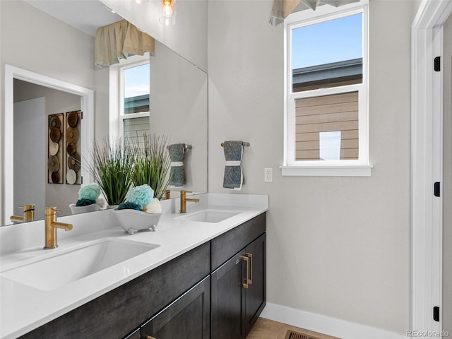 6244 N Lisbon St, Aurora, CO 80019 - bathroom with baseboards and double vanity