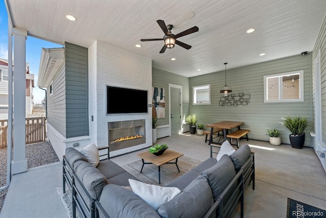 6244 N Lisbon St, Aurora, CO 80019 - view of patio with an outdoor living space with a fireplace, ceiling fan, and fence