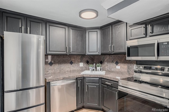 1390 N Emerson St Unit 101, Denver, CO 80218 - kitchen with stainless steel appliances, light countertops, and backsplash