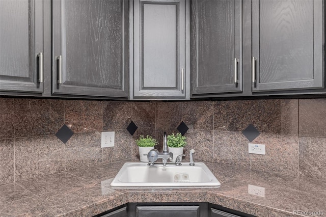 1390 N Emerson St Unit 101, Denver, CO 80218 - kitchen view of tile countertops, decorative backsplash, and gray cabinetry