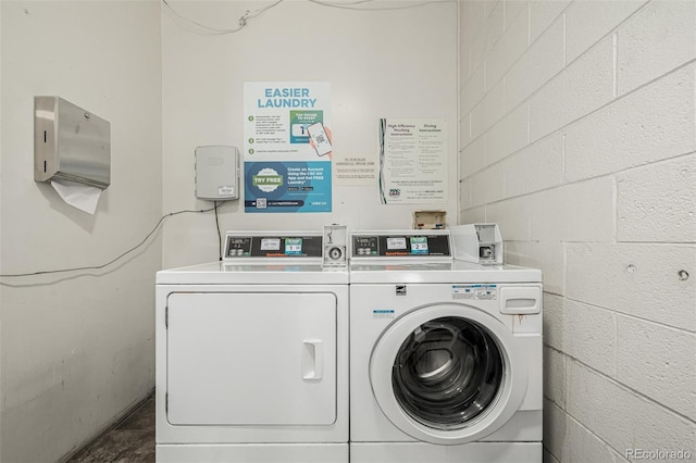 1390 N Emerson St Unit 101, Denver, CO 80218 - community laundry room featuring independent washer and dryer and concrete block wall