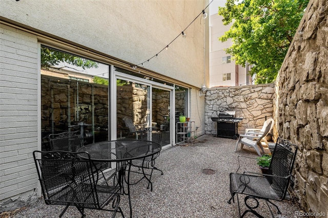 1390 N Emerson St Unit 101, Denver, CO 80218 - view of patio featuring a grill and outdoor dining space