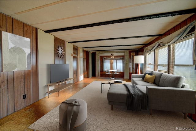 6224 County Road H, Joes, CO 80822 - living room featuring wooden walls, a ceiling fan, and beamed ceiling