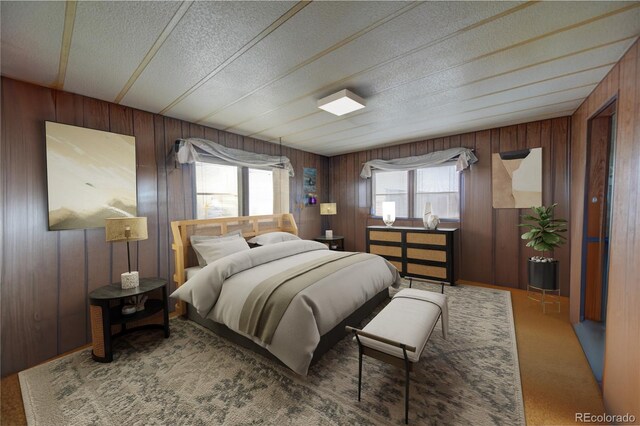 6224 County Road H, Joes, CO 80822 - carpeted bedroom featuring multiple windows, wooden walls, and a textured ceiling