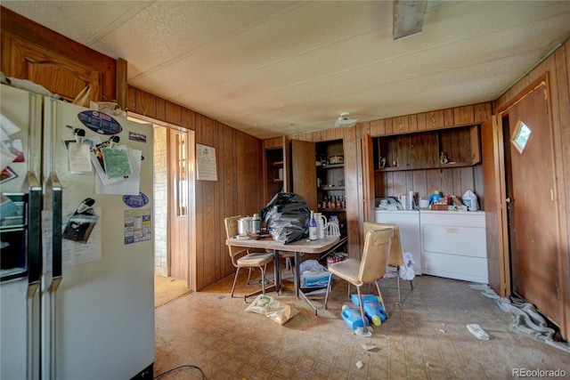 6224 County Road H, Joes, CO 80822 - dining room featuring wooden walls, washing machine and dryer, plenty of natural light, a textured ceiling, and tile patterned floors