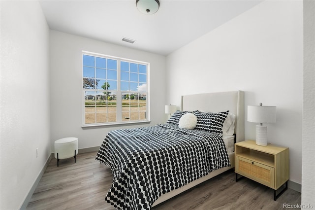 bedroom with wood-type flooring