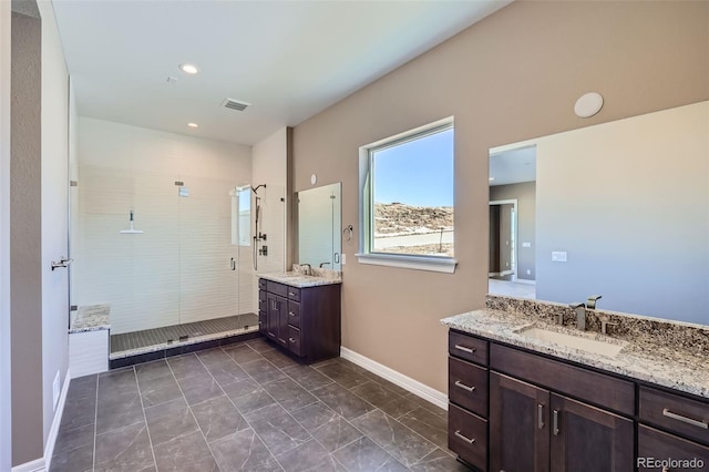 bathroom featuring an enclosed shower and vanity