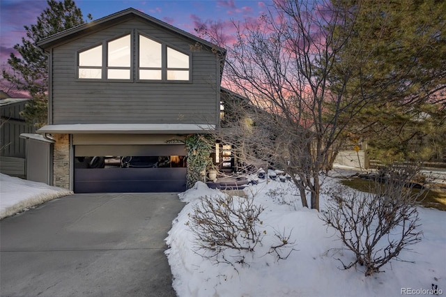 view of snow covered exterior featuring a garage