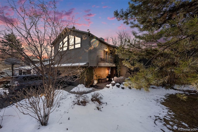 view of snow covered exterior featuring a balcony