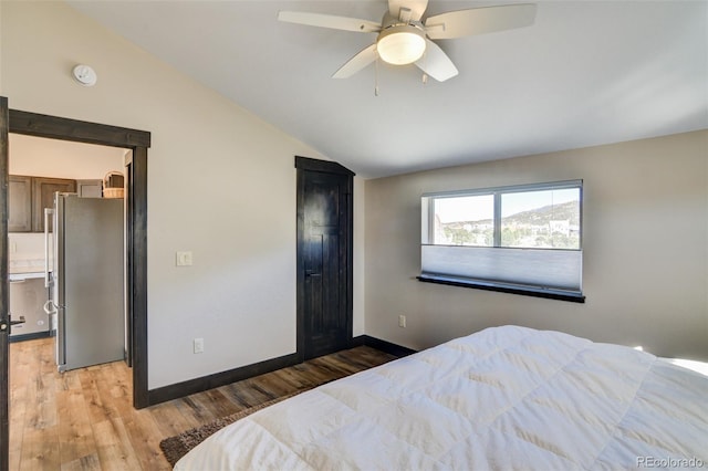 104 River Run Dr, Buena Vista, CO 81211 - bedroom with freestanding refrigerator, lofted ceiling, light wood-type flooring, a spacious closet, and a ceiling fan