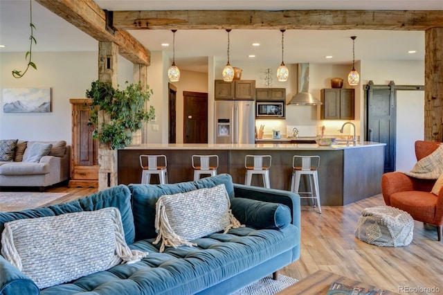 104 River Run Dr, Buena Vista, CO 81211 - living room featuring light wood-style floors, recessed lighting, a barn door, and beam ceiling
