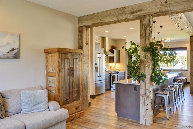 104 River Run Dr, Buena Vista, CO 81211 - kitchen with appliances with stainless steel finishes, light wood-style flooring, open floor plan, light countertops, and a kitchen bar