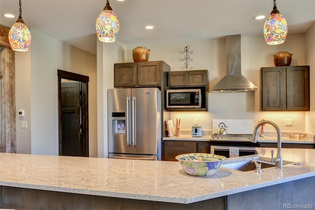 104 River Run Dr, Buena Vista, CO 81211 - kitchen with appliances with stainless steel finishes, wall chimney range hood, recessed lighting, pendant lighting, and light stone countertops