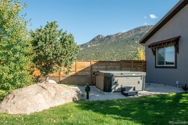 104 River Run Dr, Buena Vista, CO 81211 - fenced backyard with a hot tub and a mountain view
