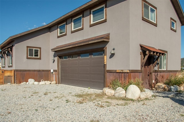 104 River Run Dr, Buena Vista, CO 81211 - view of front of property with an attached garage and stucco siding