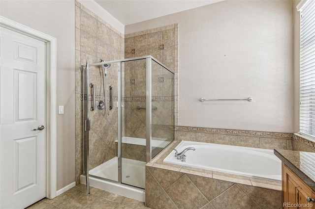 6085 Nile Cir, Golden, CO 80403 - bathroom featuring a bath, a stall shower, tile patterned floors, and vanity
