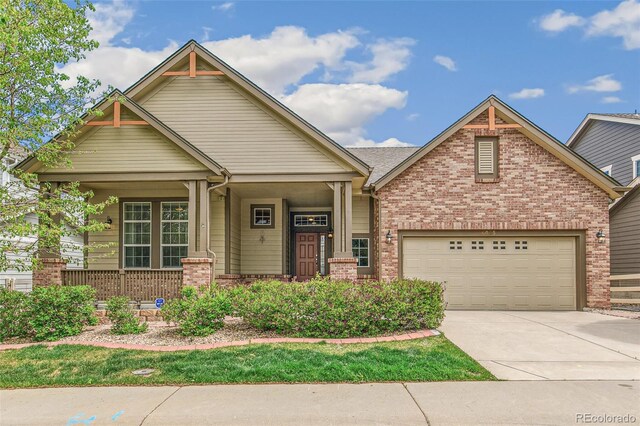 6085 Nile Cir, Golden, CO 80403 - craftsman house featuring brick siding, concrete driveway, and a porch