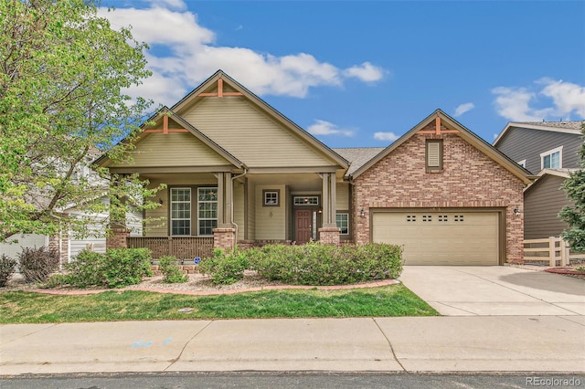 6085 Nile Cir, Golden, CO 80403 - craftsman house featuring brick siding, driveway, a porch, and a garage
