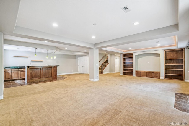 6085 Nile Cir, Golden, CO 80403 - unfurnished living room with wet bar, stairway, recessed lighting, light carpet, and a tray ceiling