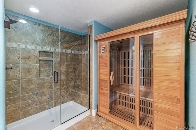 6085 Nile Cir, Golden, CO 80403 - full bathroom featuring a relaxing sauna, a shower stall, tile patterned flooring, a textured ceiling, and recessed lighting
