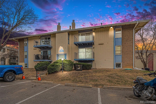 property at dusk with uncovered parking
