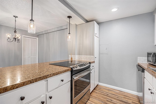 kitchen featuring baseboards, hanging light fixtures, white cabinets, appliances with stainless steel finishes, and light wood-type flooring