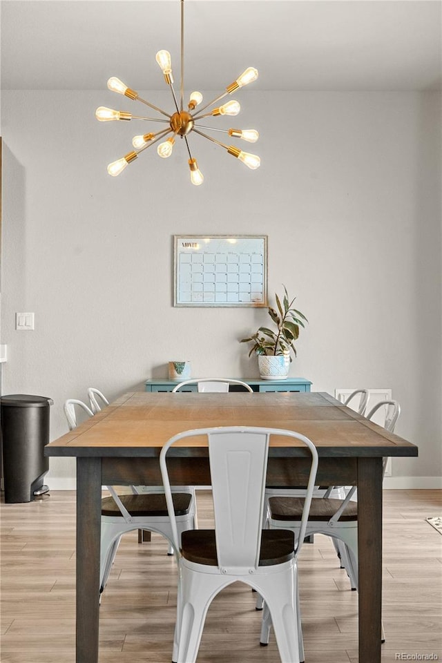 244 Chipeta Way, Lochbuie, CO 80603 - dining area with a chandelier and light wood-style flooring