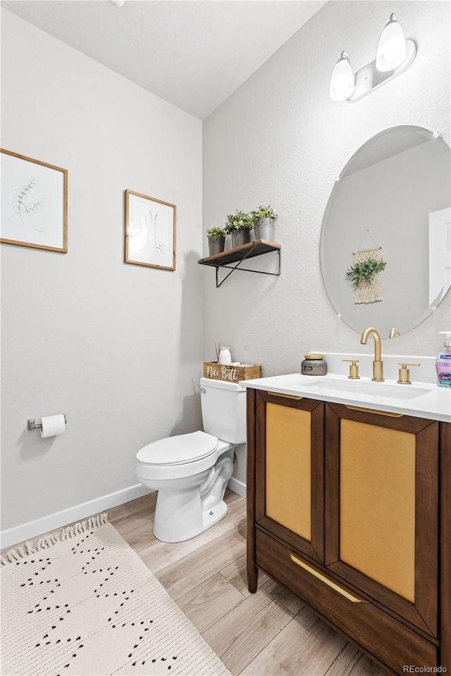 244 Chipeta Way, Lochbuie, CO 80603 - half bathroom featuring wood finished floors and vanity