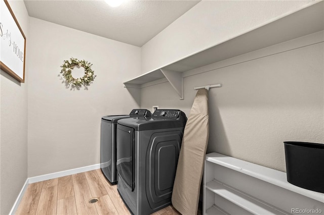 244 Chipeta Way, Lochbuie, CO 80603 - laundry room featuring washing machine and clothes dryer and light wood-style flooring