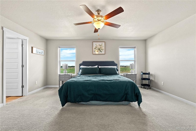 244 Chipeta Way, Lochbuie, CO 80603 - bedroom featuring light carpet, multiple windows, a textured ceiling, and ceiling fan