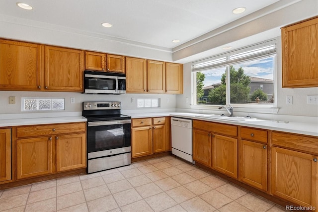 4848 Fenwood Dr, Highlands Ranch, CO 80130 - kitchen with appliances with stainless steel finishes, light countertops, brown cabinetry, recessed lighting, and light tile patterned floors