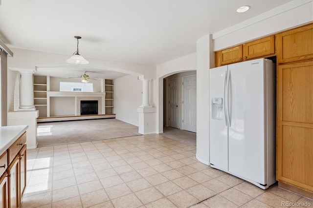 4848 Fenwood Dr, Highlands Ranch, CO 80130 - kitchen featuring white fridge with ice dispenser, ceiling fan, ornate columns, a glass covered fireplace, and recessed lighting