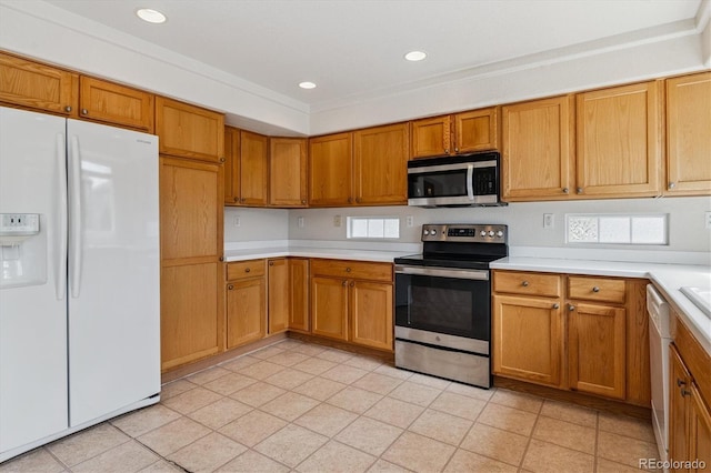 4848 Fenwood Dr, Highlands Ranch, CO 80130 - kitchen with stainless steel appliances, light countertops, brown cabinetry, light tile patterned floors, and recessed lighting