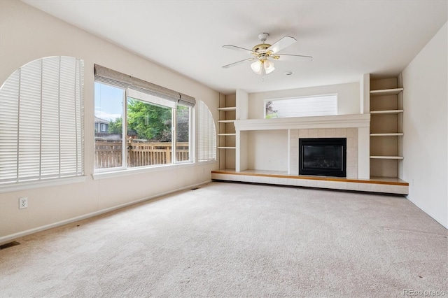 4848 Fenwood Dr, Highlands Ranch, CO 80130 - unfurnished living room featuring carpet floors, ceiling fan, and a tiled fireplace