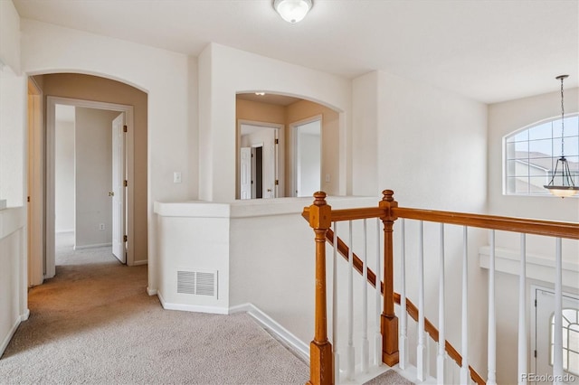 4848 Fenwood Dr, Highlands Ranch, CO 80130 - hallway with carpet flooring, arched walkways, and an upstairs landing