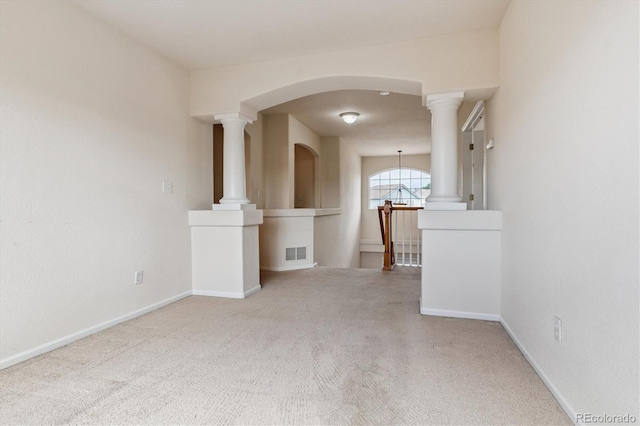 4848 Fenwood Dr, Highlands Ranch, CO 80130 - empty room featuring carpet flooring, decorative columns, and arched walkways