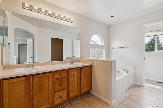 4848 Fenwood Dr, Highlands Ranch, CO 80130 - bathroom featuring double vanity, a bath, and tile patterned floors