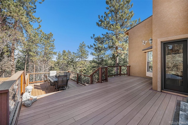 wooden deck featuring outdoor dining space